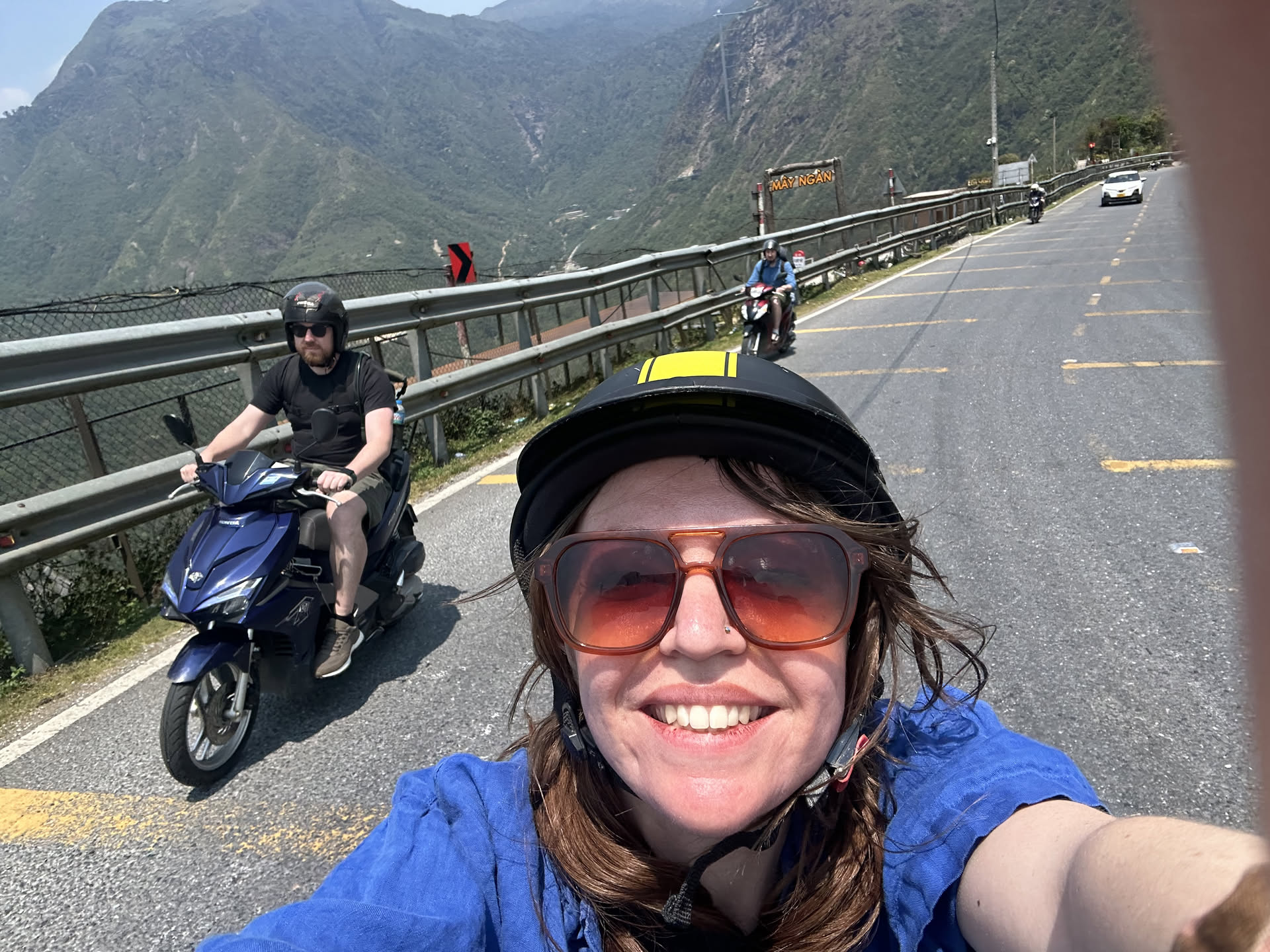 Heather riding through the mountains on a scooter adventure